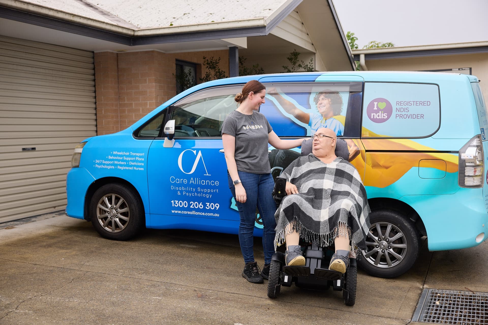 Care Alliance support worker with a participant beside the accessible van