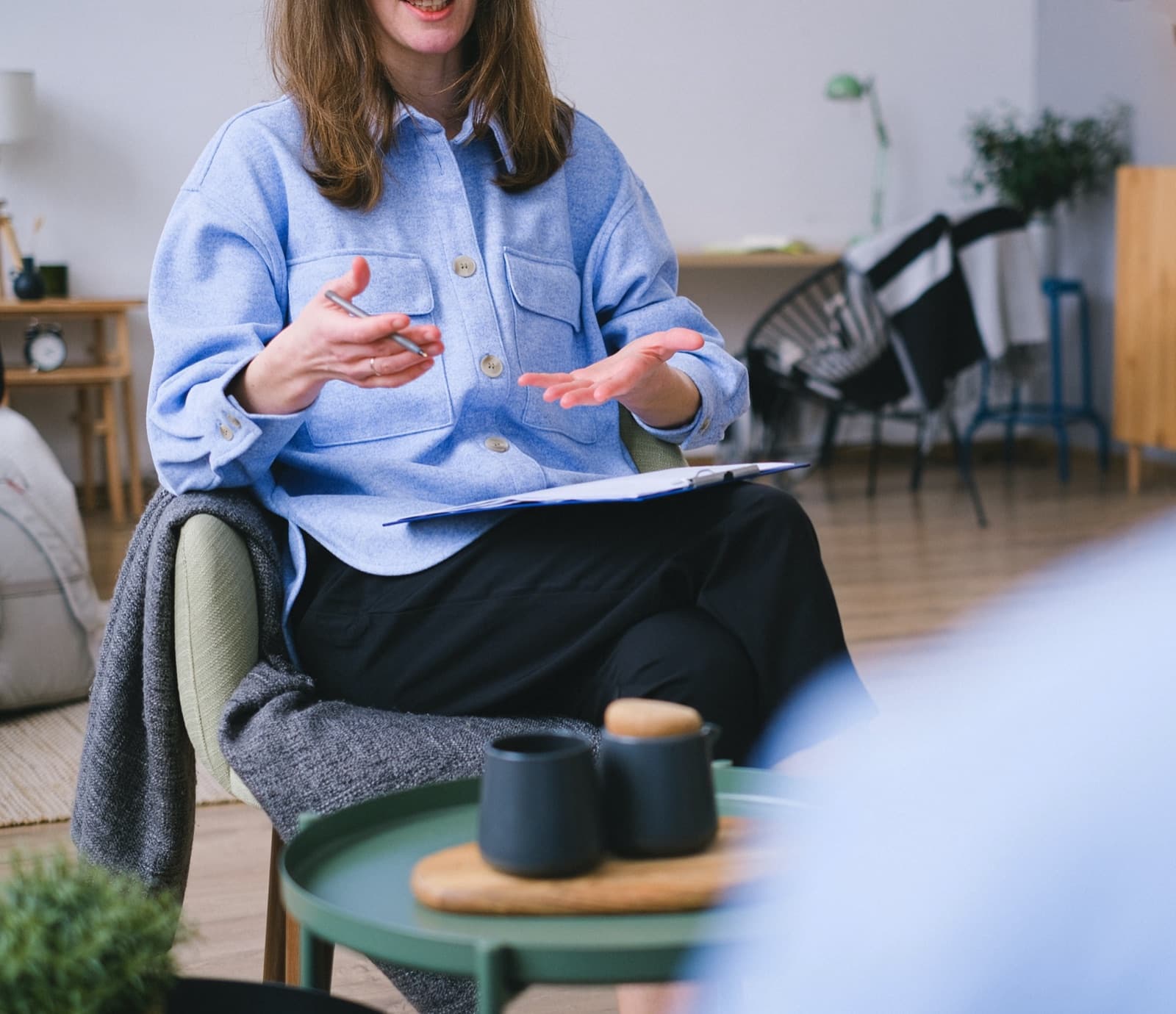 Psychologist talking with a client in a comfortable clinic room