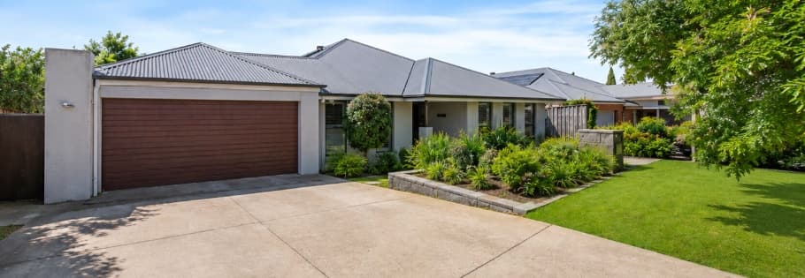 Driveway and double garage beside the landscaped front garden